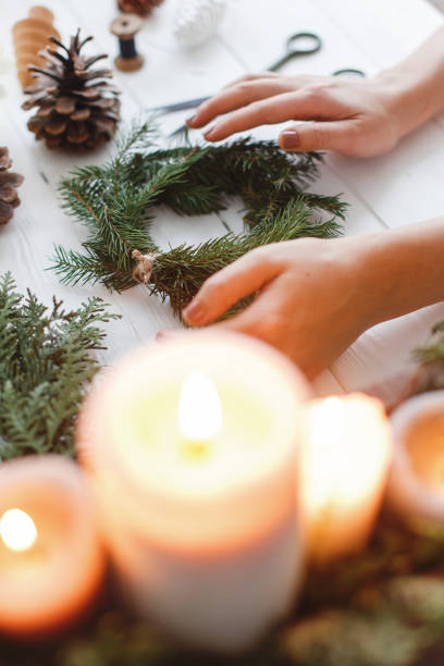 istock Florist hands making simple stylish christmas wreath with fir branches 1273366192