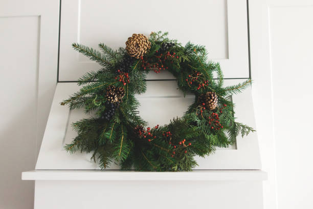 istock Rustic christmas wreath hanging on modern kitchen hood, festive holiday decoration. 1273366251