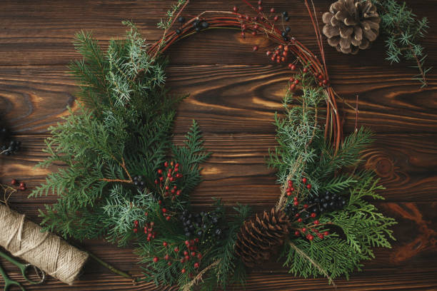istock Modern rustic christmas wreath on wooden table flat lay, holiday advent. 1273366289