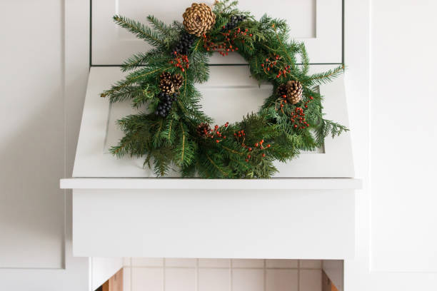 istock Creative modern christmas wreath hanging on stylish kitchen cabinets. 1273366529