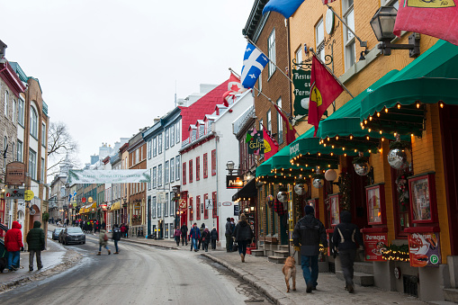 Quebec, Canada - December 25, 2019. Visitors walking on sidewalks in historic district of Quebec City, Canada