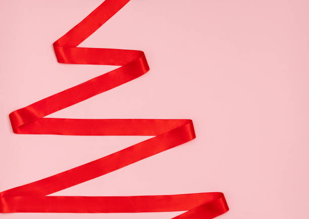 istock Red ribbon in the shape of a Christmas tree. 1273366680