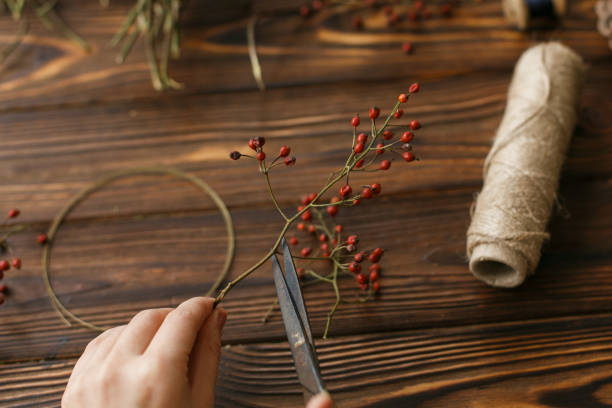 istock Making christmas wreath on rustic wooden table, holiday advent. 1273367322