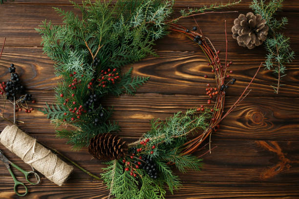 istock Rustic christmas wreath on wooden table flat lay, holiday advent. 1273367412