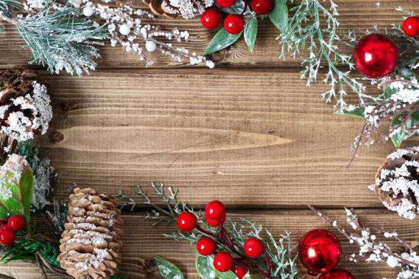 istock Merry Christmas composition. Fir branches with cones, berries and snow decorations on old dark wooden background with copy space for text, flat lay top view 1273367802
