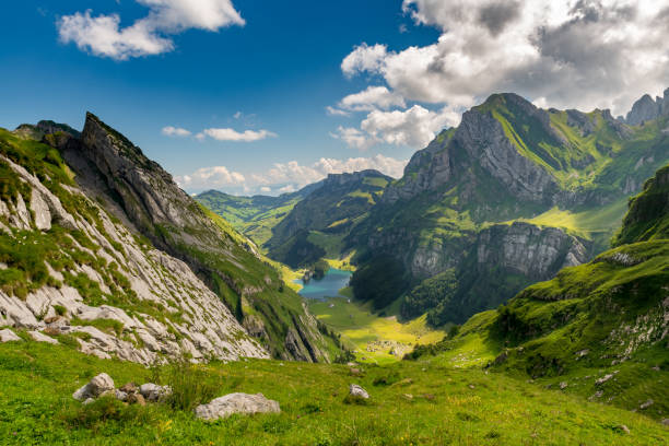 View from above of the Seealpsee, surrounded by the Swiss Alps. Canton of Appenzell, Switzerland. View of the Seealpsee in the Swiss Alps. Canton of Appenzell, Switzerland. appenzell stock pictures, royalty-free photos & images