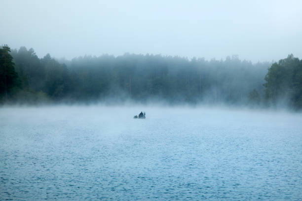 istock Foggy Lake With A Fisherman 1273370344