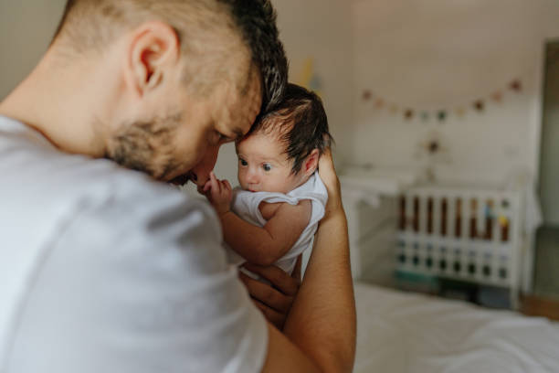 istock Father and a baby in a nursery 1273371590