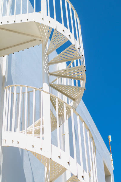 istock white spiral staircase against the blue sky 1273371961