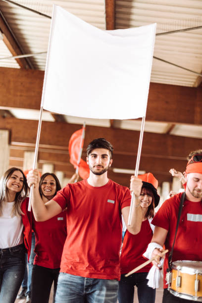 istock friends with blank sign at the stadium 1273372044