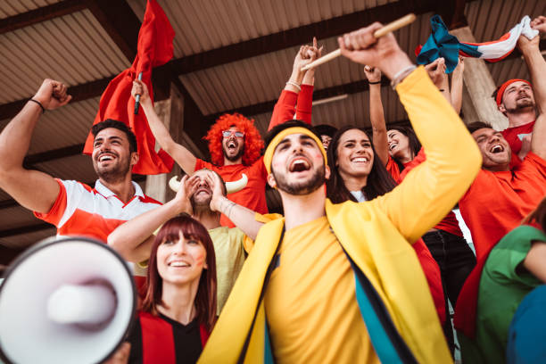 amigos animando en el estadio con megáfono - campeonato europeo de fútbol fotografías e imágenes de stock