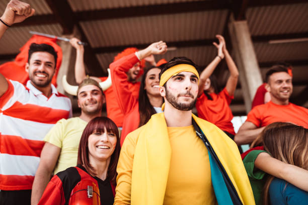 istock friends cheering at the stadium with megaphone 1273372099