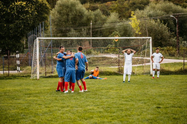 istock Soccer players  celebrating a goal 1273372798