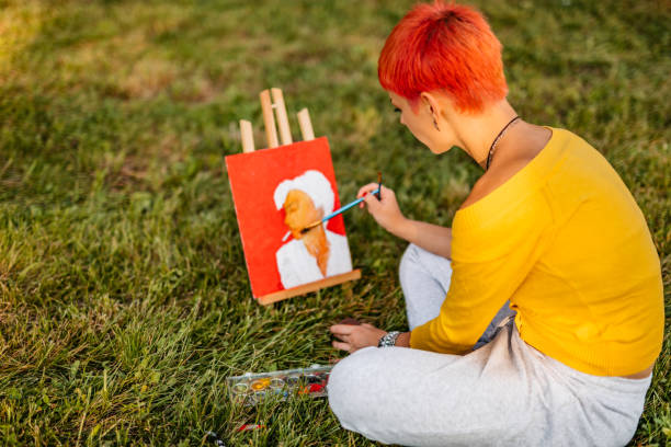istock Woman painting on meadow 1273373748