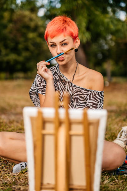 istock Woman painting on meadow 1273373964