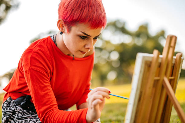 istock Woman painting on meadow 1273373995