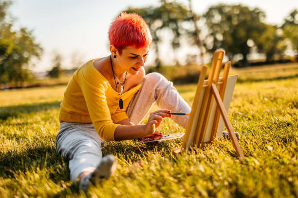 Woman painting on meadow