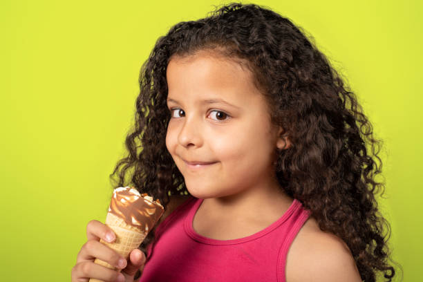 istock Happy child with ice cream cone with green background, selective focus. 1273375195