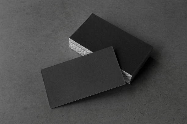istock Business card on black background. 1273375584