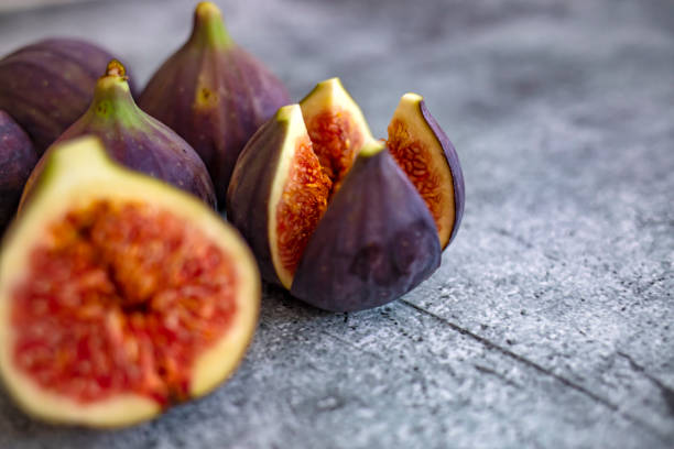 istock Ripe sweet figs with green leaves 1273375688