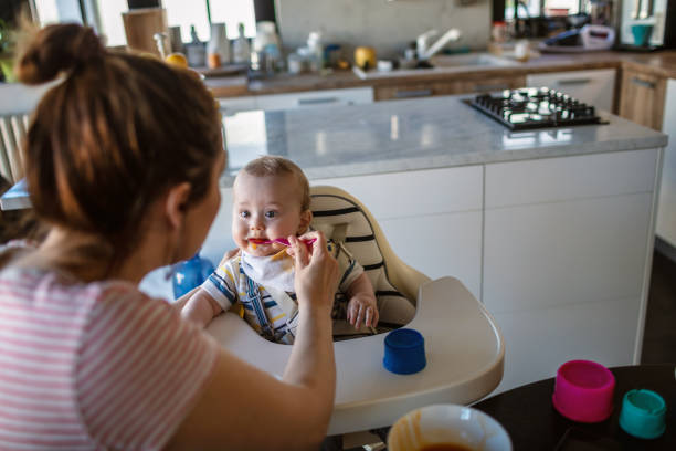 istock Mother feeds her baby son 1273376530