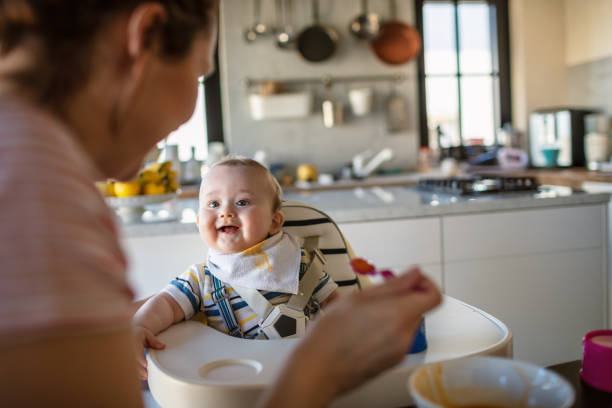 istock Mother feeds her baby son 1273377348