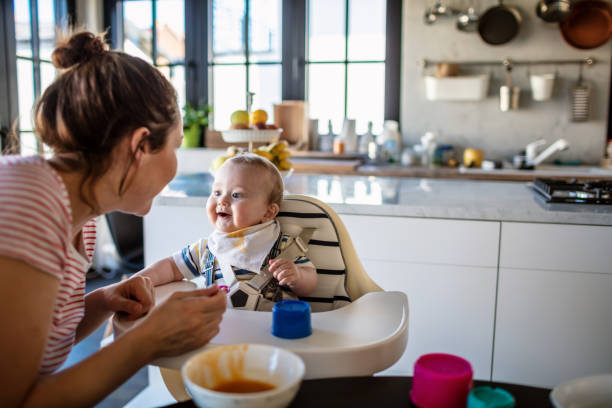 istock Mother feeds her baby son 1273377602