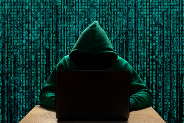 istock Hacker in the hood at the computer. Cyber espionage and digital security 1273378498