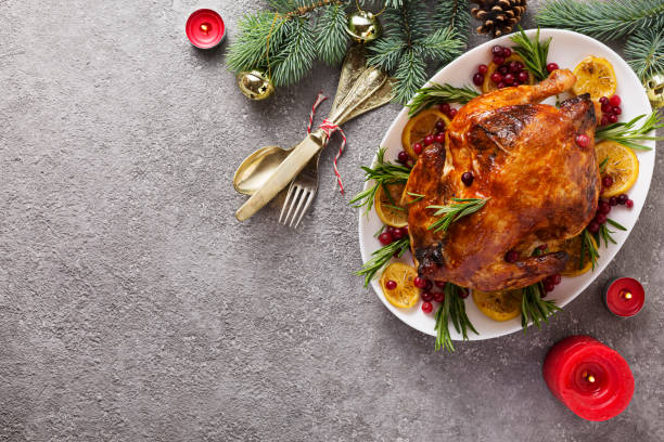 istock Christmas table with baked chicken is festively decorated with candles. 1273378514