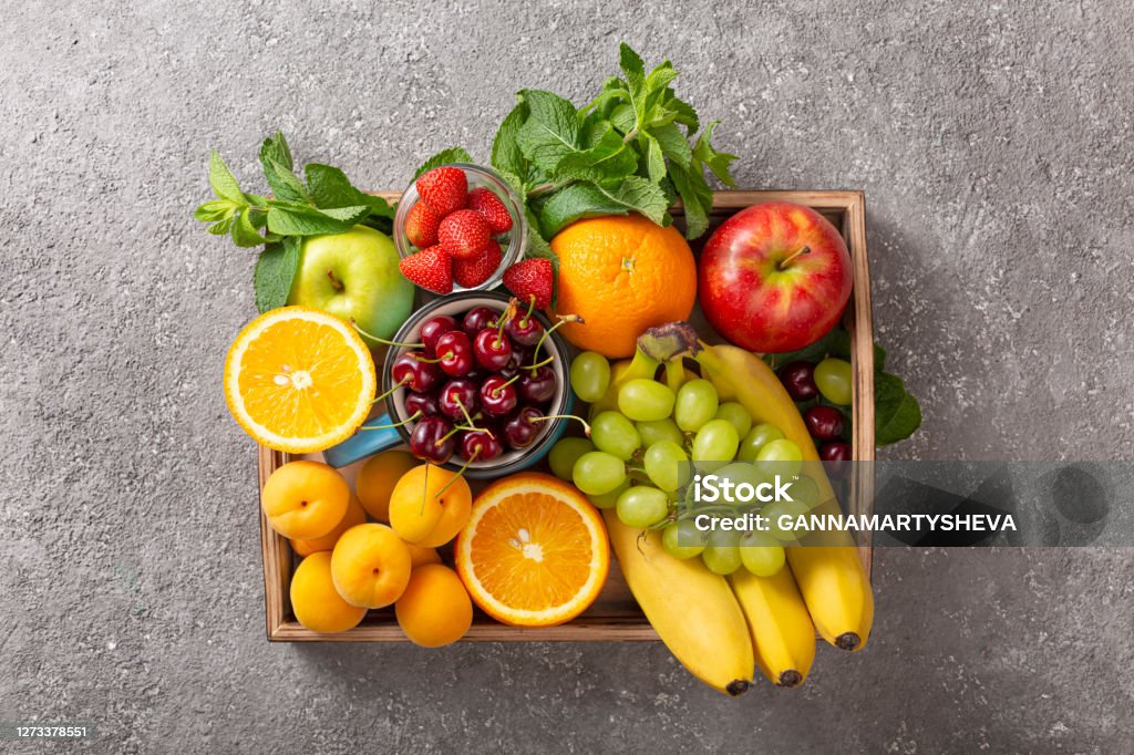 Set of summer fruits and berries in wooden serving. Fruit Stock Photo
