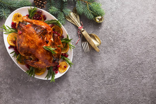 istock Christmas table with baked chicken is festively decorated with candles. 1273378666
