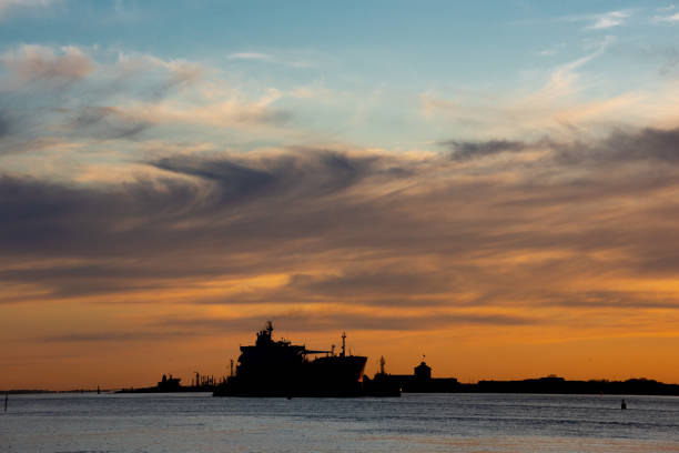 istock Silhouettes of freight ships at sunset 1273382560
