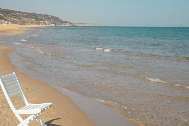 istock white chair by the beach 1273384680