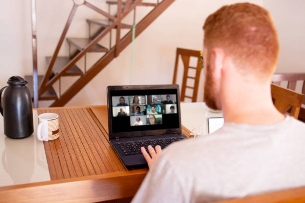 istock Young man using laptop at home in a video conference 1273387787