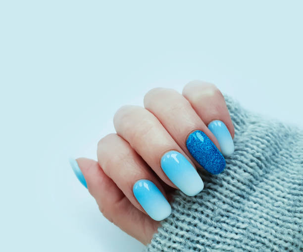 istock female hand beautiful manicure sweater 1273387802