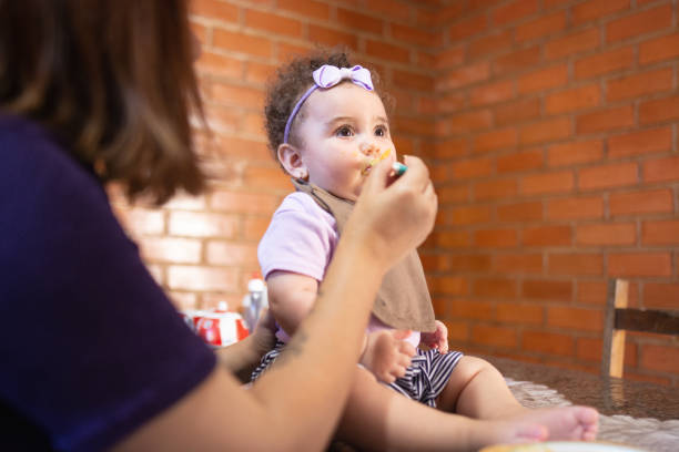 istock Mom feeding her baby daughter 1273387822