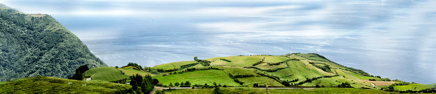 This photograph was taken on August 30, 2020 on the island of Sao Miguel in the Azores. It is the Pico dos Bodes viewpoint. The trail begins near the access path to the Pico dos Bodes vantage point.  There is a wide road which leads onto pastureland at the start of the trail, which narrows into a single track. About half way along the trail there is a rock garden, followed by a series of tight bends, with stony areas, ending with two tight bends followed by the final stretch of asphalt.