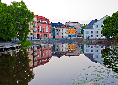 Bright colored buildings, reflected in the Fyris River in Uppsala, Sweden.
