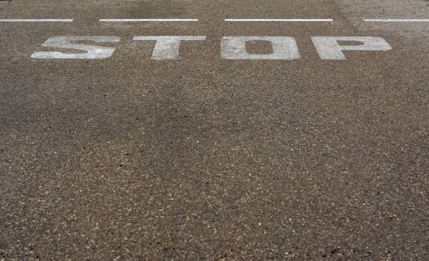 istock stop sign painted on the asphalt 1273390722