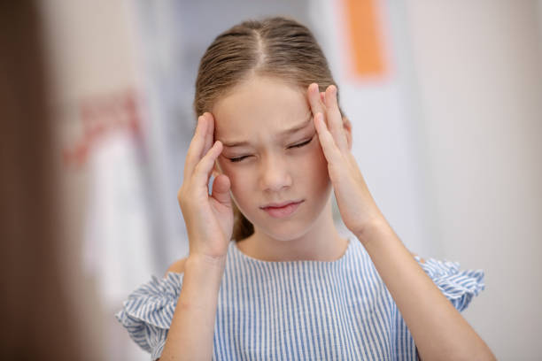 istock Girl having a headache and looking unhappy 1273390864