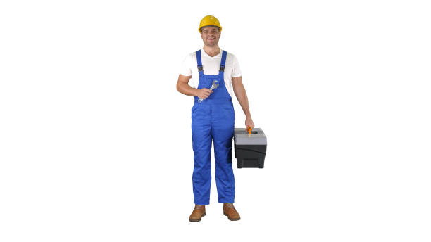 istock A repairman holding a toolbox and wrench smiling to camera on white background 1273398921