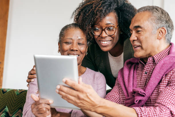 istock Senior couple with daughter watching video 1273400222