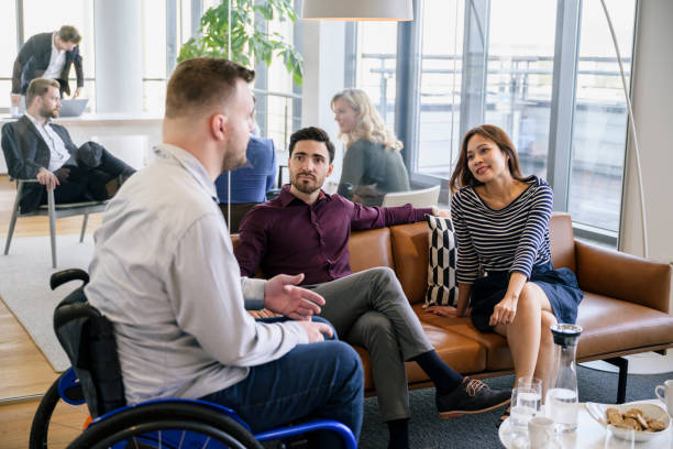 istock Diverse business people sharing ideas in office lobby 1273400285