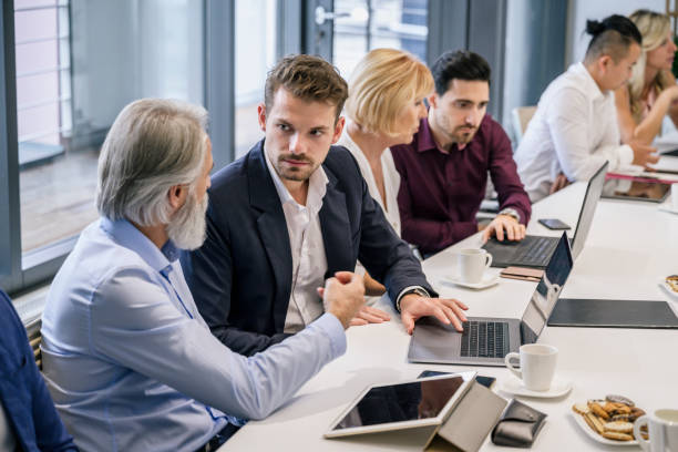 istock Young businessmen mentored by senior executives 1273400290