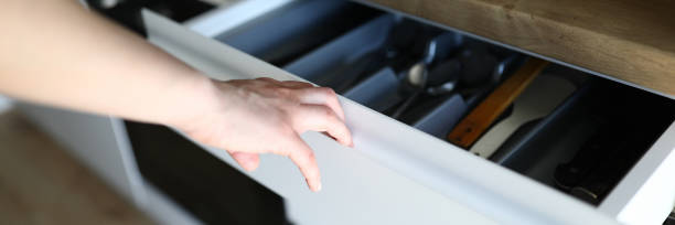 istock Female hand opens kitchen drawer with cutlery 1273400546