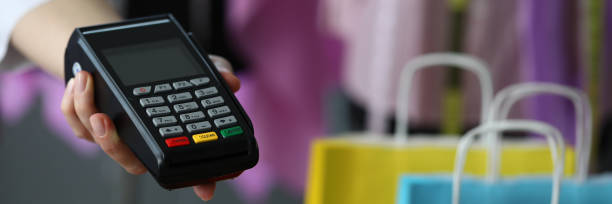 istock Hand holds out terminal for credit card payment 1273400570