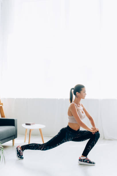 istock Selective focus of brunette woman doing lunges at home 1273404725