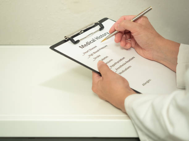 istock Female Physician Writing on Medical Form 1273406567