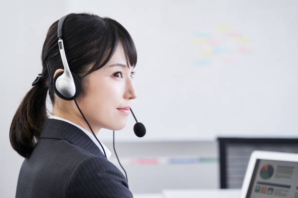 istock A Japanese woman in her office answering questions 1273408704