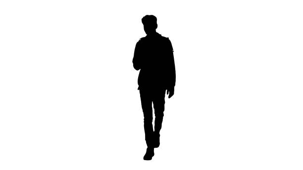 istock Silhouette Young man in casual clothes text messaging on cell ph 1273408763
